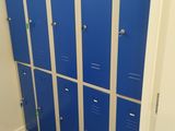several blue lockers are lined up in a row in a room