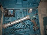 a blue tool in a blue case with a cord
