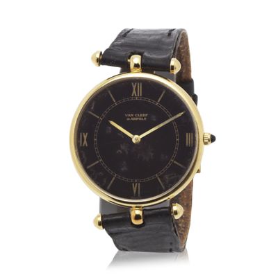 a close up of a wrist watch with roman numerals on the face