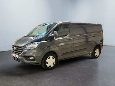 the grey van is parked in a room with a black floor