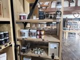 a wooden shelf with jars and jars on it in a store
