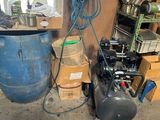 an image of a room with a bunch of boxes and a compressor