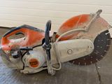an orange and white circular saw sitting on top of a concrete floor