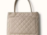 a close up of a handbag on a white surface with a white background