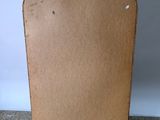 a cardboard board sitting on the floor next to a white wall