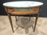 a marble topped table with a drawer underneath it
