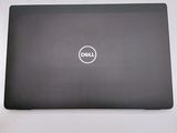 the dell laptop is sitting on a table with its lid open