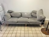 a couch that is sitting in the middle of a room