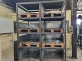 a room with a lot of shelves and a lot of bins