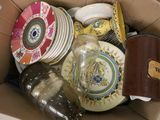 a cardboard box full of plates and bowls in it