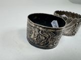 two silver cups sitting on a table with a price tag