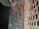 a close up of a metal grate with a sign on it