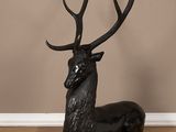 a close up of a statue of a deer on a wooden floor