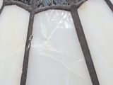 a close up of a light fixture with a glass shade on it