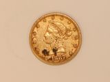 a close up of a gold coin on a white surface