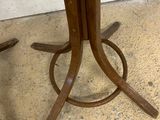 a wooden table with a metal base on the floor