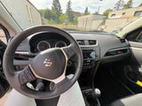 a steering wheel and dashboard of a car in a parking lot