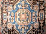 an antique persian rug with a blue and red design