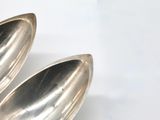 two spoons that are sitting on a table
