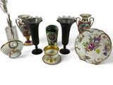 a lot of different vases and plates on the table