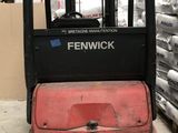 a fork lift truck that is parked in a warehouse