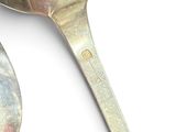 two spoons that are sitting next to each other