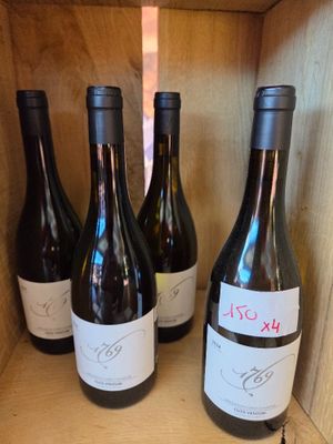 several bottles of wine are lined up in a wooden box