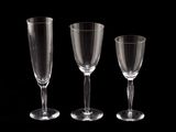 three empty wine glasses sitting next to each other