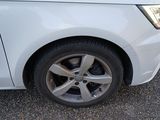 a close up of a car ' s tire on the road
