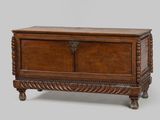 an old wooden chest sitting on top of a wooden table