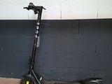 a scooter that is leaning against a wall