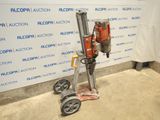 an image of a drill on a dolly in front of a wall