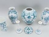 several pieces of blue and white vases and cups on a white surface