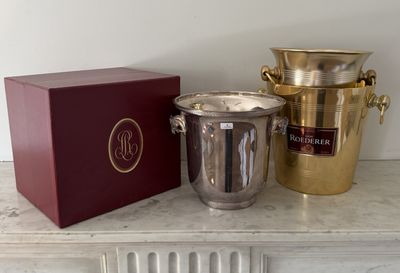 two champagne buckets and a wine cooler on a table