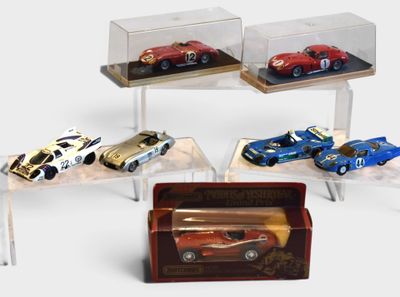 five different model cars on display in a display case