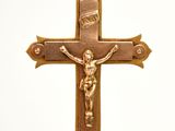 a cross with a crucif on it hanging from a chain