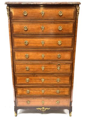 a wooden chest of drawers with brass handles and brass hardware
