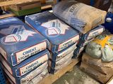 many bags of cement sitting on a pallet in a warehouse