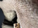a close up of a person ' s glove with a tag on it