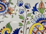 a decorative plate with a blue and yellow design on it