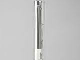a glass tube with a toothbrush in it on a table