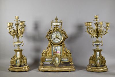 three gold and white clocks sitting next to each other on top of a table