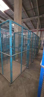 many cages in the building that have animals inside of them