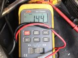 an image of a multimeter sitting on top of a table next to other tools