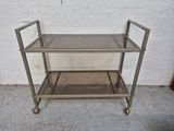 a metal cart that is sitting on the ground
