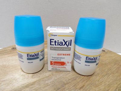 two bottles of eliaxil sitting on a table next to a box of pills
