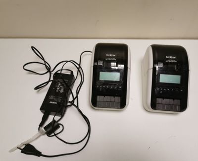 two cell phones sitting next to each other on a table