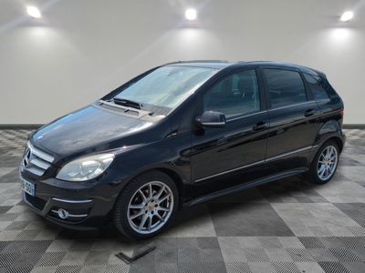 the mercedes b - class is parked in a garage with a checkered floor