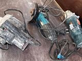 two electric tools that are laying on the floor