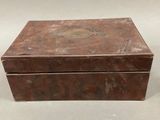 an old wooden box sitting on top of a white table